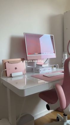 a white desk with a pink chair and computer on it in front of a wall