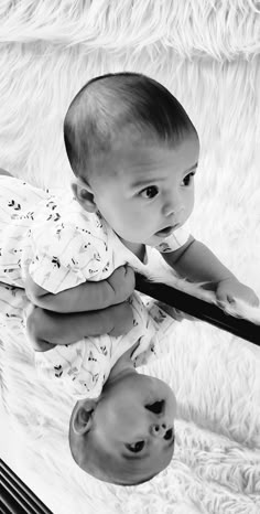 a black and white photo of a baby with a tie