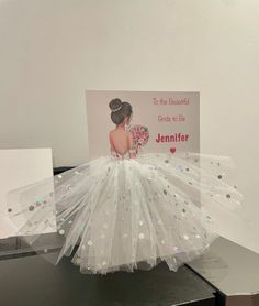 there is a card that has been made to look like a dress with sequins on it