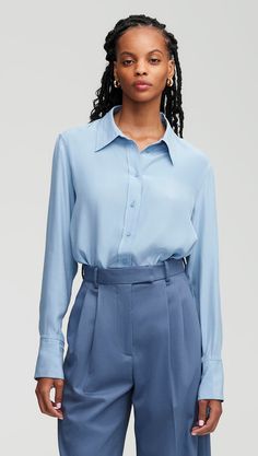 Made of a lightweight silk charmeuse, this slim fit blouse is bound to be your new go-to. The long-length button-up features lined lapels, a silk charmeuse combo lining the cuffs, and side slit hems. Wear this top partially tucked, fully tucked, or untucked with your favorite pair of trousers. Casual Hair, Slim Blouse, Trousers Details, Belted Blazer, Fitted Blouses, Work Wear Women, Silk Charmeuse, Formal Casual, Slate Blue