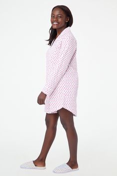 You sleep better in cute pajamas — it's science. The Perlita Lounge Dress is a super soft cotton nightshirt with a button front and front pocket. The pink hearts print adds a fanciful touch to a classic sleep style. 6 Buttons Front Patch Pocket Materials and Care 100% Long-Staple Premium Cotton Machine Wash Cold, With Like Colors Do Not Bleach, Tumble Dry Low (Line Dry Recommended) Imported Measurement Information Model Wears Size Small Size S Length: 34.5" (from Shoulder) Size S Sleeve Length: Pink Cotton Nightgown For Overnight, Fitted Casual Sleepwear, Cotton Fitted Sleepwear For Sleepover, Pink Cotton Sleepwear For Overnight, Fitted Cotton Sleepwear For Overnight, Hearts Print, Roller Rabbit, New Heart, Heart Quilt