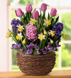 a basket filled with lots of purple and yellow flowers