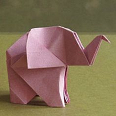 an origami elephant sitting on top of a table