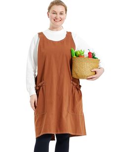 a woman in an apron holding a basket full of vegetables and smiling at the camera