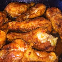 some chicken wings are cooking in a pan