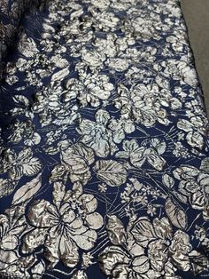 an image of a blue and silver cloth with flowers on it