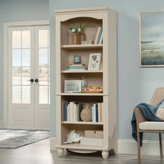 a living room with a chair and book shelf