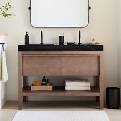 a bathroom with a sink, mirror and towel rack in it's center area