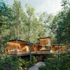 the house is surrounded by trees and has two levels that are connected to each other