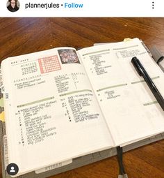 an open planner book sitting on top of a wooden table