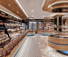 a bakery filled with lots of different types of breads and pastries on display