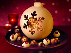 a plate with chocolate candies and an ornament on it