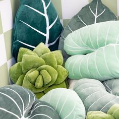 green and white pillows sitting next to each other