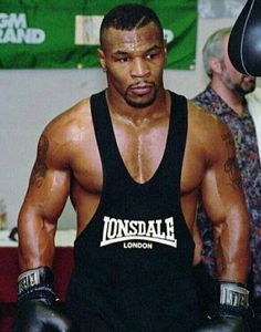 a man in black shirt and boxing gloves