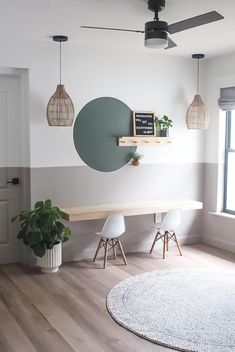 a living room with white walls and wooden flooring, two planters on the wall