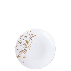 a white plate with gold leaves and birds on the rim, against a white background