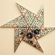 an origami star is shown on the wall