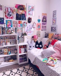 a bed room with a neatly made bed and lots of pictures on the wall