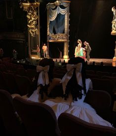 an empty theater with people dressed in costumes