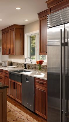 a kitchen with wooden cabinets and stainless steel appliances