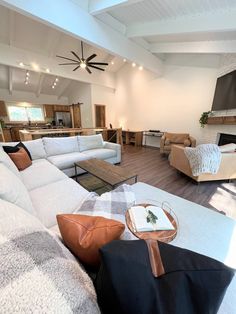 a living room filled with furniture and a flat screen tv mounted to the wall over a fireplace