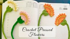 crochet flower bookmarks are displayed on an open notebook