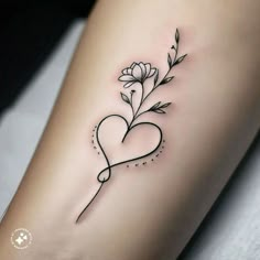 a heart shaped tattoo with flowers on the side of the arm and an arrow in the middle