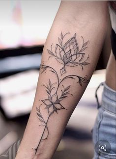 a woman's arm with a flower tattoo on the left side of her body