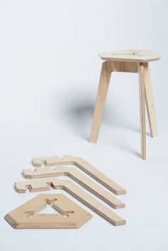 several pieces of wood sitting next to each other on a white surface with one piece missing