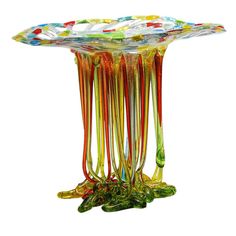 a glass table with many different colored sticks sticking out of it