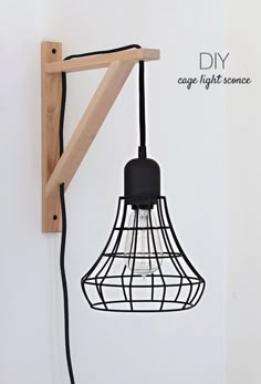 a light that is hanging from a wooden frame on a wall with the words diy cage light science idea hack