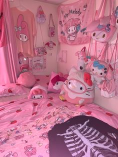 a hello kitty themed bedroom with pink bedding and accessories on the walls, along with skeleton pillows