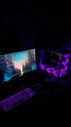 two computer monitors sitting next to each other in the dark with purple lighting on them