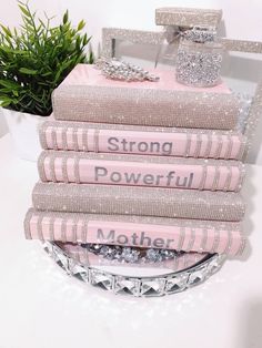 a stack of pink books sitting on top of a table