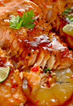 a close up of food on a plate with garnishes and limes