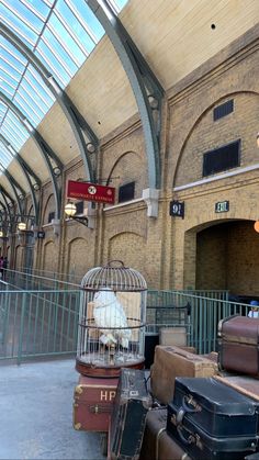 several suitcases stacked on top of each other in front of a train station entrance