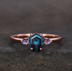 a blue diamond ring with three stones on it