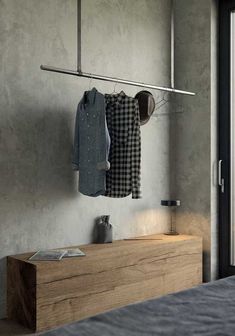 clothes hanging on a rail in a bedroom