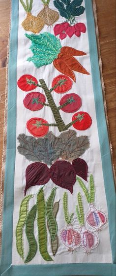 an embroidered table runner with flowers on it