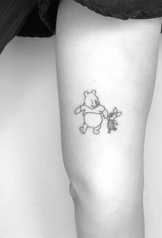 a black and white photo of a person with a small tattoo on their leg,