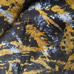 black and yellow paint splattered on fabric