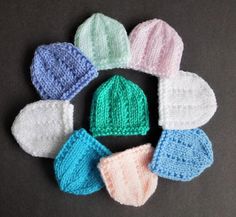 several knitted hats are arranged in a circle