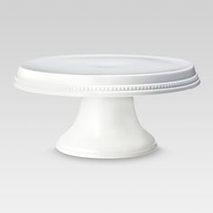 a white cake plate sitting on top of a table