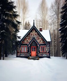 a small cabin in the middle of a snowy forest with red door and window frames