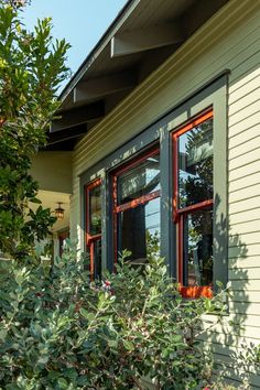 a house with red windows and green shutters