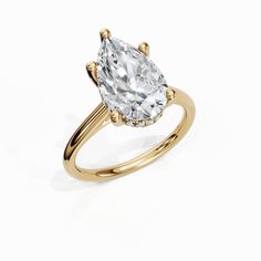 a yellow gold ring with an oval cut diamond