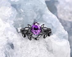 an amethorate ring sitting on top of ice