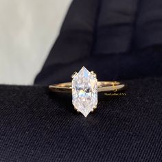 a diamond ring sitting on top of a black cloth