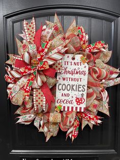 a christmas wreath is hanging on the front door with its saying it's not christmas without cookies and coca cola