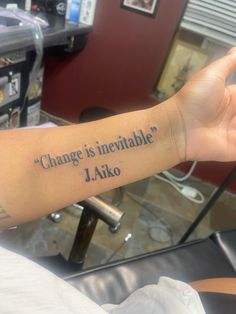 a person with a tattoo on their arm saying change is in inevitable j ako